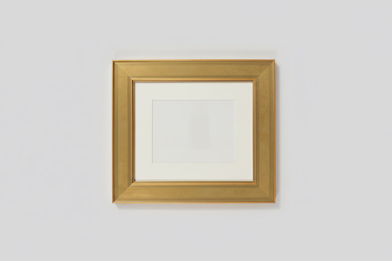 Gold picture frame on a wooden surface